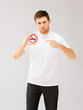 young man pointing at no smoking sign