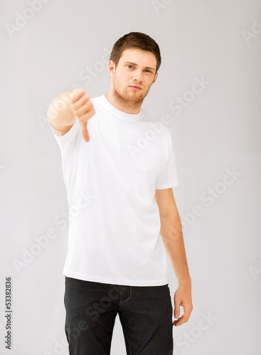 Photo: man showing thumbs down man showing thumbs down