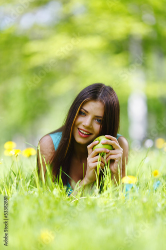 Photo: Woman with apple outdoors Woman with apple outdoors