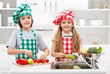 Foto: Kids helping in the kitchen - washing and slicing vegetables Kids helping in the kitchen - washing and slicing vegetables