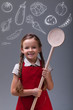 Photo: Young girl with apron and large wooden spoon Young girl with apron and large wooden spoon