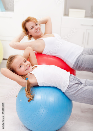 Photo: Woman and little girl exercising Woman and little girl exercising