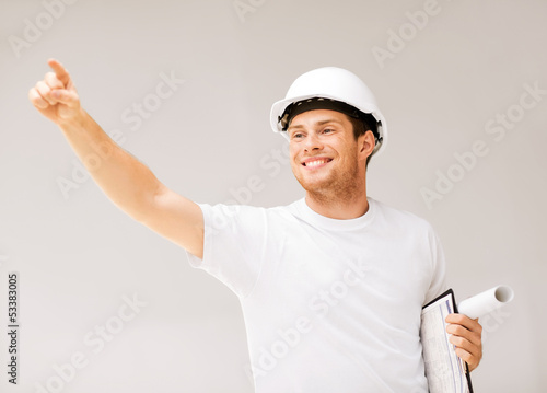 Photo: male architect looking at blueprint male architect looking at blueprint