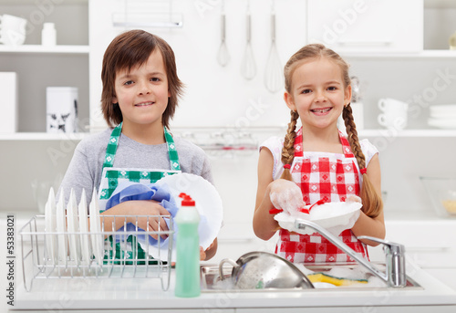 Photo: Happy kids helping in the kitchen Happy kids helping in the kitchen