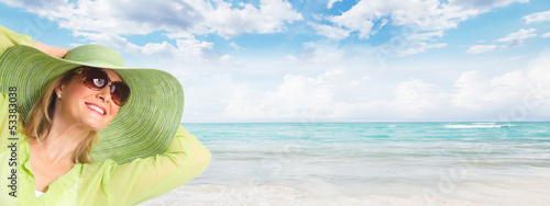 Photo: Senior woman wearing sunglasses and a hat. Senior woman wearing sunglasses and a hat.