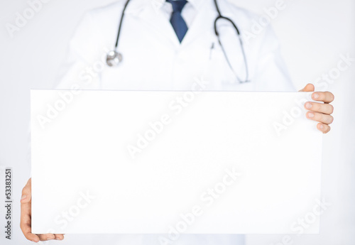 Photo: doctor holding blank white banner doctor holding blank white banner