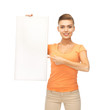 Photo: woman pointing at white blank board woman pointing at white blank board