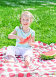 Photo: Pretty little girl eating watermelon in the park Pretty little girl eating watermelon in the park