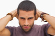 Handsome man posing with hands on head
