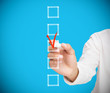 Businesswoman ticking a box in red