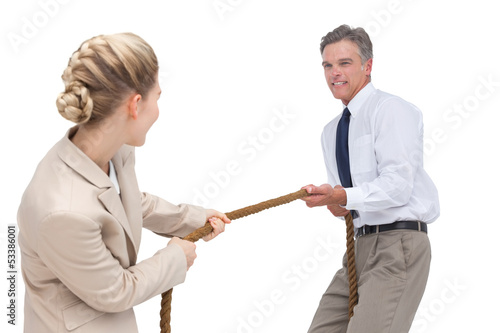 Photo: Business people competing in pulling rope Business people competing in pulling rope