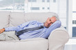 Photo: Businessman lying on sofa resting Businessman lying on sofa resting