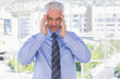 Stressed businessman rubbing his temples