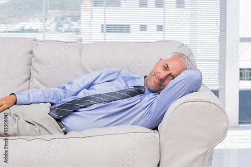 Photo: Businessman lying on sofa resting Businessman lying on sofa resting