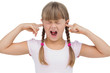 Funny little girl clogging her ears and wincing
