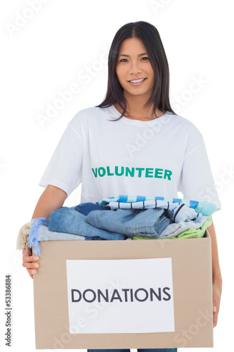 Photo: Happy woman carrying donation box Happy woman carrying donation box