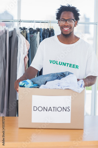 Photo: Handsome man holding a donation box Handsome man holding a donation box