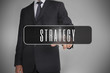 Businessman selecting label with strategy written on it