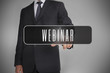 Businessman selecting label with webinar written on it