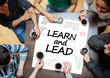 Learn and lead written on a poster with drawings of charts