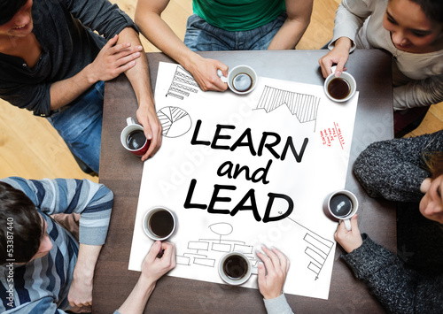 Photo: Learn and lead written on a poster with drawings of charts Learn and lead written on a poster with drawings of charts