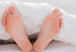 Feet sticking out from the duvet