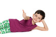 Photo: Lying boy holds his thumb up Lying boy holds his thumb up