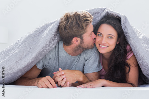Photo: Handsome man kissing his wife Handsome man kissing his wife
