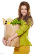 Young woman holding a grocery bag full of bread