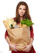 Young woman holding a grocery bag full of bread
