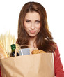 Young woman holding a grocery bag full of bread