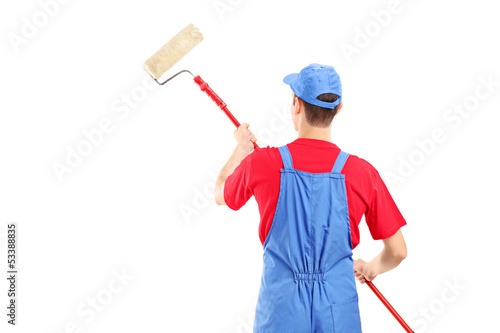 Photo: Man in a uniform painting a wall Man in a uniform painting a wall