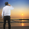 Businessman talking on the phone at the beach