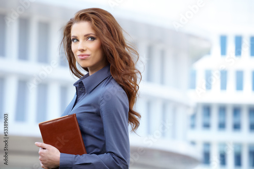 Photo: Young happy women or student on the property business background Young happy women or student on the property business background