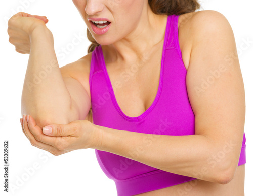 Photo: Closeup on woman with elbow pain Closeup on woman with elbow pain