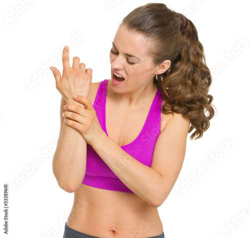 Photo: Fitness young woman with wrist pain Fitness young woman with wrist pain