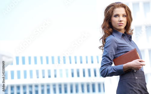 Photo: Young happy women or student on the property business background Young happy women or student on the property business background