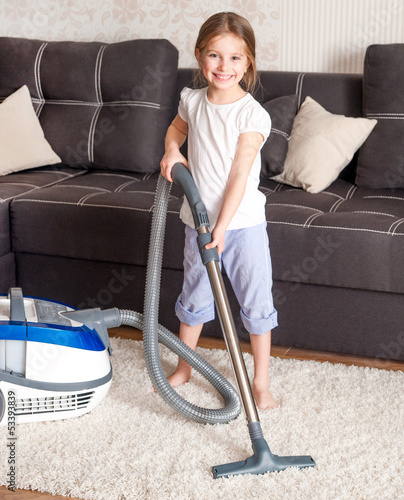 Photo: little girl cleaning the room little girl cleaning the room