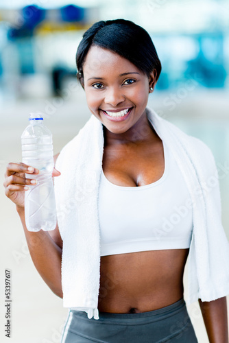 Photo: Gym woman with a bottle of water Gym woman with a bottle of water