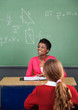 Teacher Looking Away With Female Student In Foreground