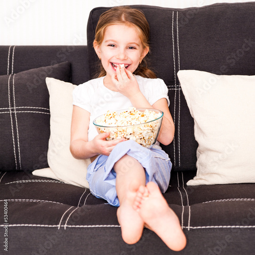 Photo: little girl watching TV little girl watching TV