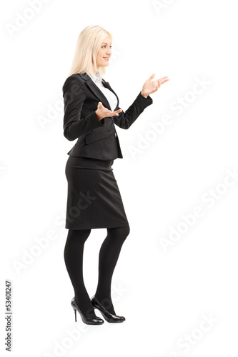 Photo: Full length portrait of a businesswoman gesturing with hands Full length portrait of a businesswoman gesturing with hands