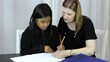 Mother Helps Asian Daughter With Homework