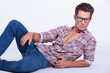 casual man laying and looking at you