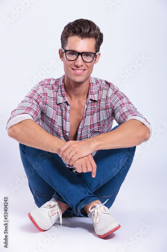 Photo: casual man sits with legs crossed casual man sits with legs crossed
