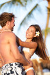 Photo: Beach couple in love having vacation summer fun Beach couple in love having vacation summer fun