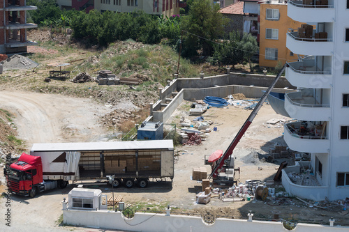 Photo: Workers unload household appliances and raise lift Workers unload household appliances and raise lift