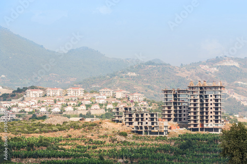 Photo: Under construction building in landscape with mountains Under construction building in landscape with mountains
