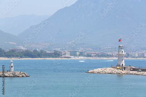Photo: Beautiful landscape with sea, lighthouse, mountain and coastline Beautiful landscape with sea, lighthouse, mountain and coastline