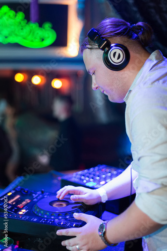 Photo: Profile portrait DJ turns the records at the club Profile portrait DJ turns the records at the club